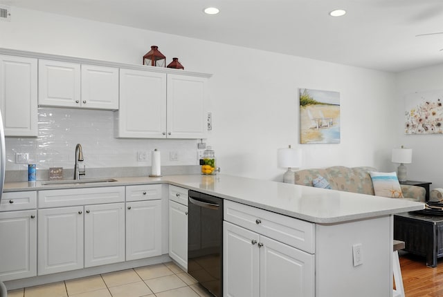 305 E Bennett Ave Unit A, Wildwood, NJ 08260 - kitchen featuring dishwasher, a peninsula, light countertops, white cabinets, and backsplash