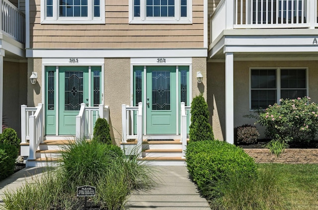 305 E Bennett Ave Unit A, Wildwood, NJ 08260 - view of exterior entry with a balcony and stucco siding