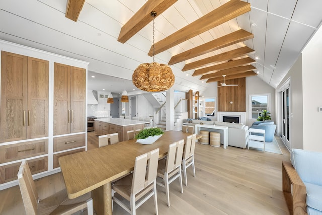 242 83rd St, Stone Harbor, NJ 08247 - dining area with stairway, light wood-style floors, and a fireplace