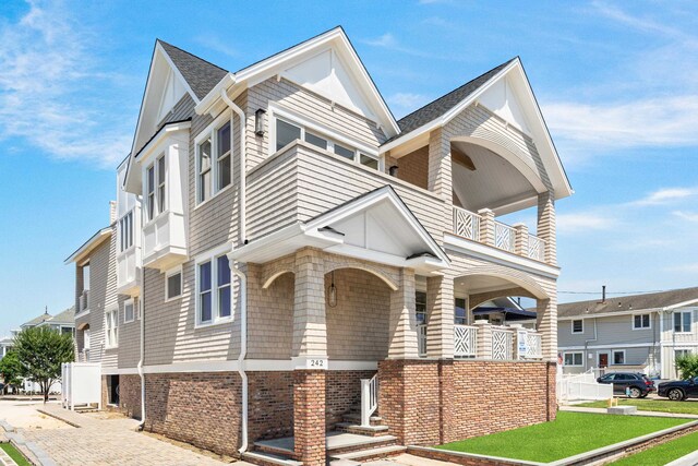 242 83rd St, Stone Harbor, NJ 08247 - view of front of home featuring a balcony and roof with shingles