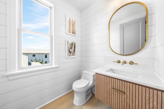 242 83rd St, Stone Harbor, NJ 08247 - half bathroom with wood finished floors, vanity, and wood walls
