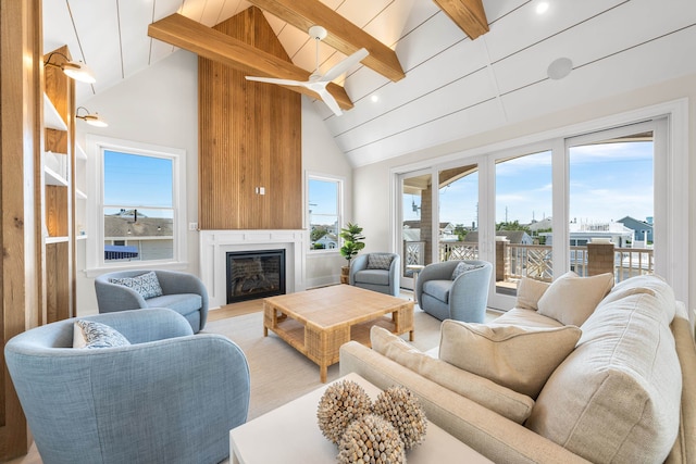 242 83rd St, Stone Harbor, NJ 08247 - living room featuring beam ceiling, high vaulted ceiling, a glass covered fireplace, and wood finished floors
