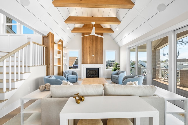 242 83rd St, Stone Harbor, NJ 08247 - living room with plenty of natural light, wood finished floors, stairway, and a large fireplace