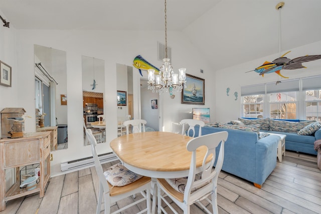 dining space with light wood-style flooring, high vaulted ceiling, baseboard heating, and ceiling fan with notable chandelier