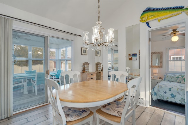 dining area with light wood-type flooring, vaulted ceiling, and a ceiling fan