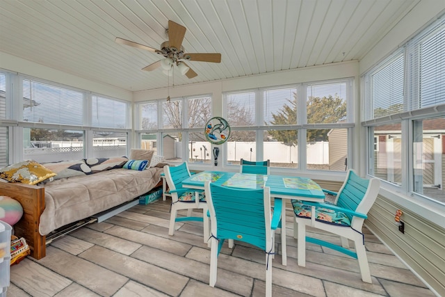 sunroom / solarium featuring wooden ceiling and a ceiling fan