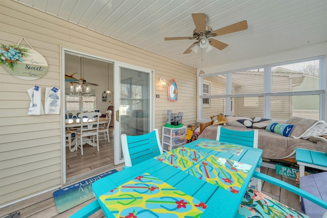 sunroom / solarium featuring a ceiling fan and a healthy amount of sunlight