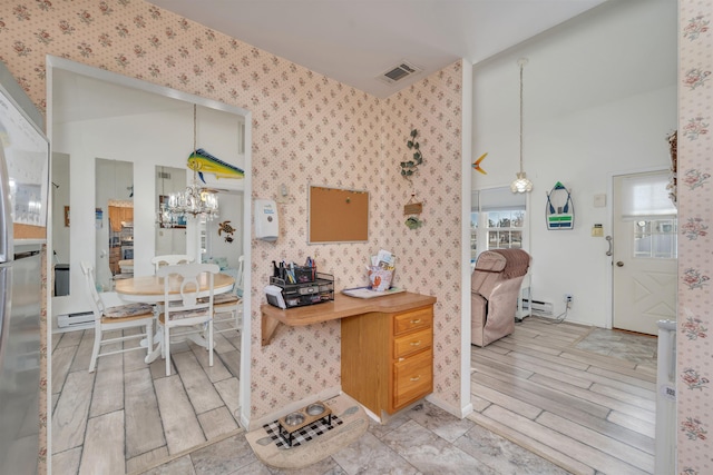 kitchen featuring visible vents, baseboard heating, wallpapered walls, decorative light fixtures, and an inviting chandelier