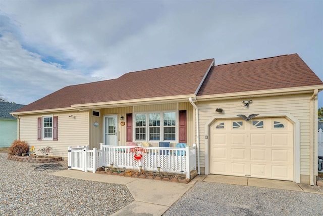 single story home with a garage, a porch, a shingled roof, and aphalt driveway