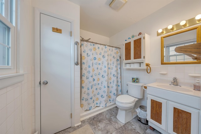 full bathroom with visible vents, toilet, curtained shower, vanity, and tile walls