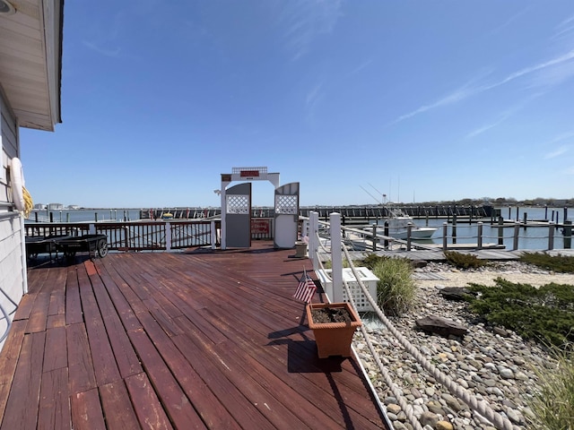 wooden terrace featuring a water view