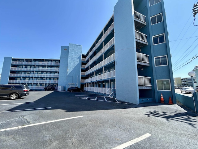 view of property featuring uncovered parking