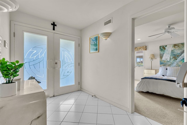 entrance foyer featuring visible vents, baseboards, ceiling fan, light tile patterned floors, and french doors