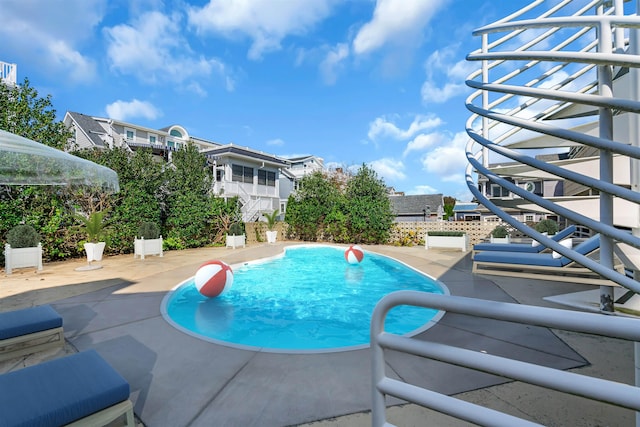 outdoor pool with a patio area