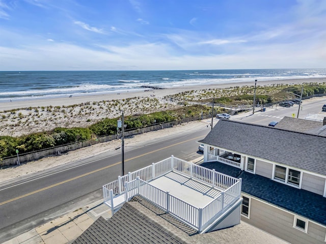 drone / aerial view featuring a water view and a beach view