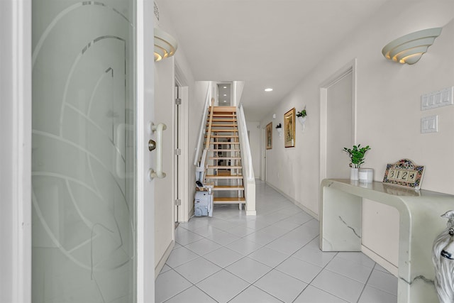 entryway featuring light tile patterned floors, stairway, baseboards, and recessed lighting