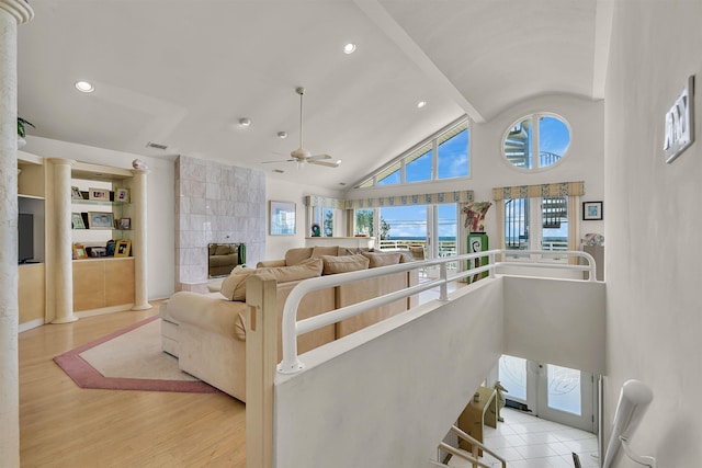 living area featuring wood finished floors, visible vents, high vaulted ceiling, recessed lighting, and beamed ceiling