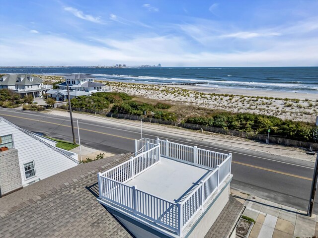 birds eye view of property with a beach view and a water view