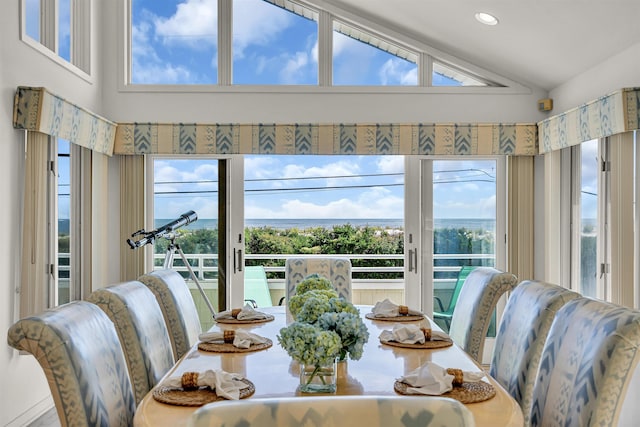 dining space featuring a wealth of natural light, lofted ceiling, and recessed lighting