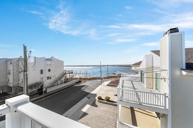 view of patio / terrace with a water view and a balcony