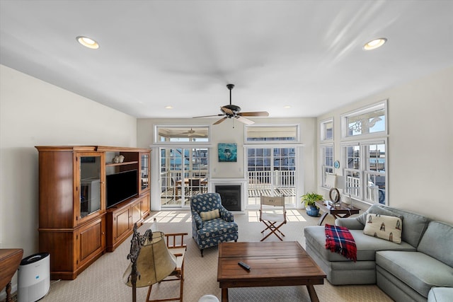 living area with recessed lighting, light colored carpet, and ceiling fan