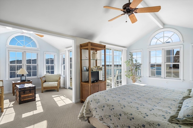 bedroom featuring lofted ceiling with beams, multiple windows, and carpet