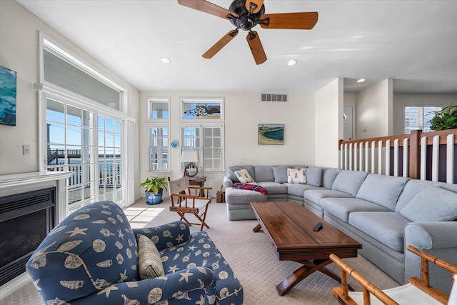 living room featuring plenty of natural light, visible vents, and recessed lighting