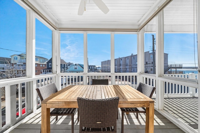 sunroom / solarium featuring ceiling fan