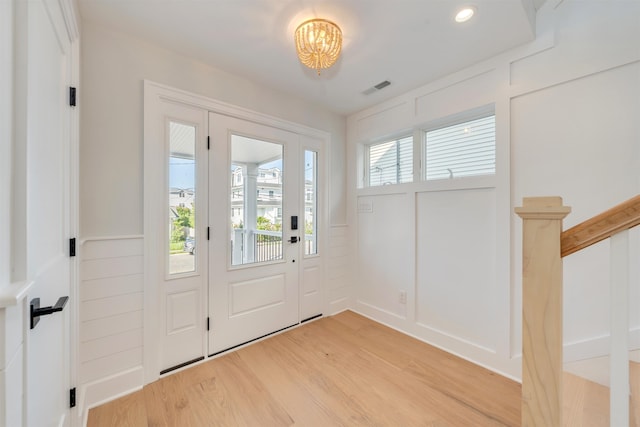520 21st St, Avalon, NJ 08202 - foyer entrance with light wood finished floors, a chandelier, and a decorative wall