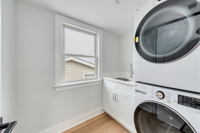 520 21st St, Avalon, NJ 08202 - washroom with stacked washing machine and dryer, cabinet space, and light wood-style flooring