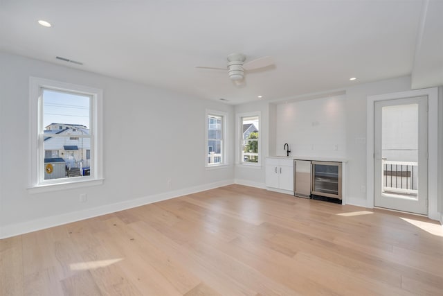 520 21st St, Avalon, NJ 08202 - unfurnished living room with wine cooler, bar area, a ceiling fan, light wood-type flooring, and recessed lighting