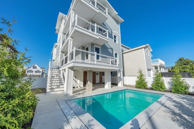 520 21st St, Avalon, NJ 08202 - back of house featuring a balcony, a patio, a fenced backyard, and stairs