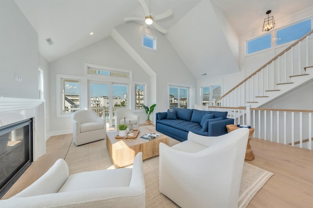 520 21st St, Avalon, NJ 08202 - living room with high vaulted ceiling, ceiling fan, light wood finished floors, and a glass covered fireplace