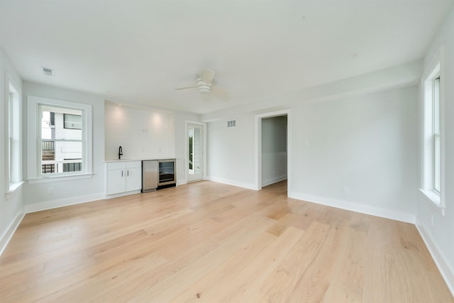 520 21st St, Avalon, NJ 08202 - unfurnished living room featuring a dry bar and plenty of natural light