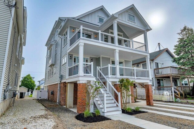 520 21st St, Avalon, NJ 08202 - coastal home with a balcony, board and batten siding, stairway, covered porch, and a garage