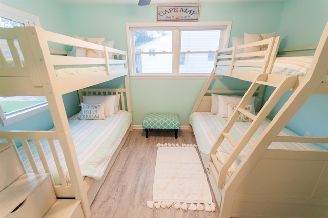 bedroom featuring wood finished floors and baseboards