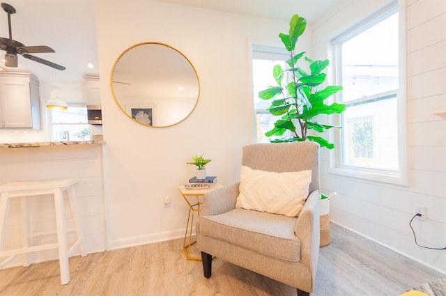 sitting room featuring light wood-style flooring and baseboards