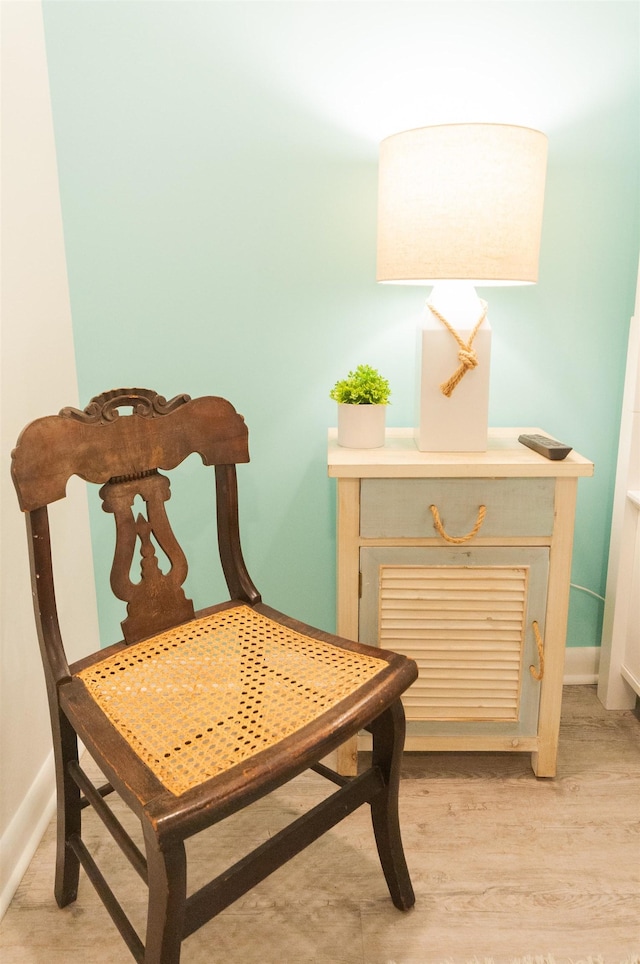 living area featuring light wood-style floors and baseboards