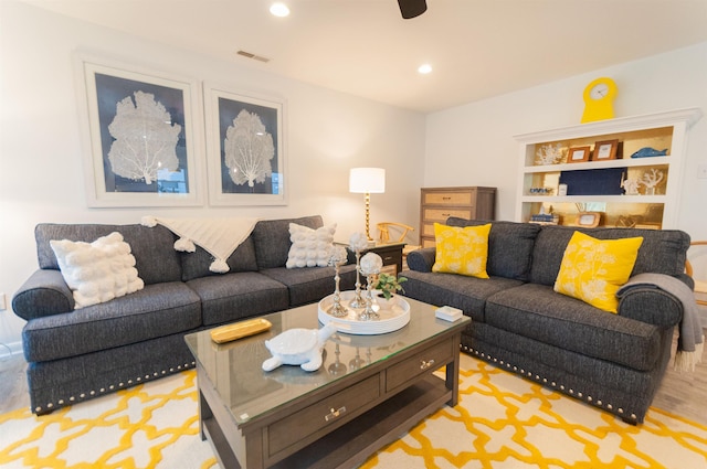 living room featuring recessed lighting and visible vents