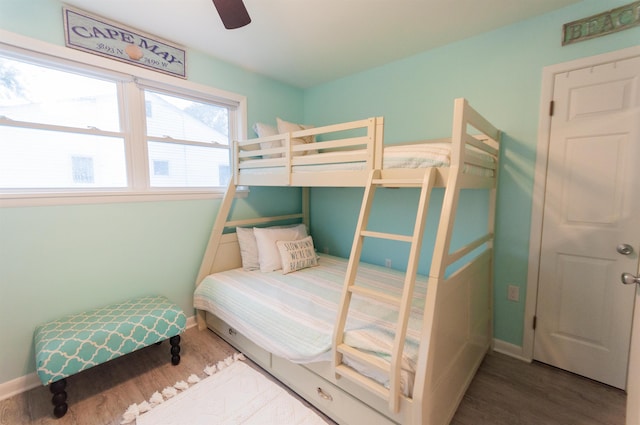 bedroom featuring ceiling fan, baseboards, and wood finished floors