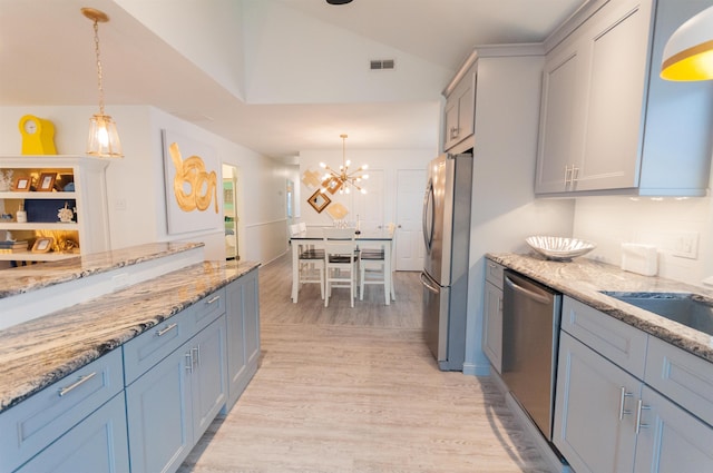 kitchen with light wood-type flooring, visible vents, appliances with stainless steel finishes, and pendant lighting