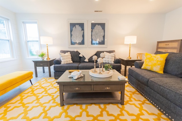 living room featuring visible vents and wood finished floors