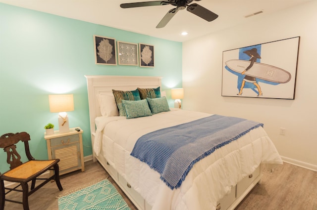 bedroom with ceiling fan, recessed lighting, wood finished floors, visible vents, and baseboards