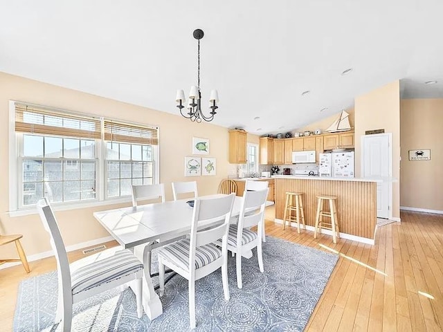 367 21st St, Avalon, NJ 08202 - dining area featuring vaulted ceiling, a chandelier, and light wood-style flooring