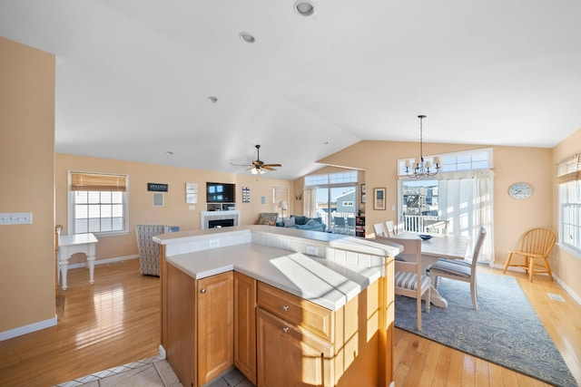 367 21st St, Avalon, NJ 08202 - kitchen with lofted ceiling, light wood-style flooring, a chandelier, light countertops, and baseboards