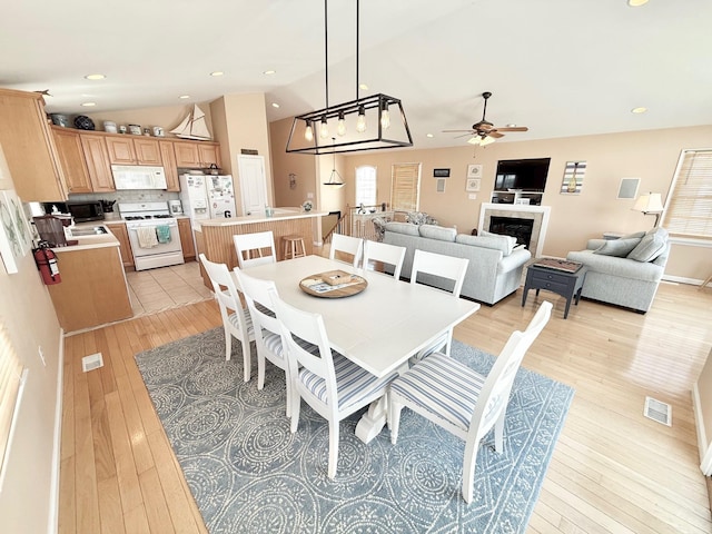 367 21st St, Avalon, NJ 08202 - dining area with ceiling fan, light wood-type flooring, a fireplace, lofted ceiling, and recessed lighting