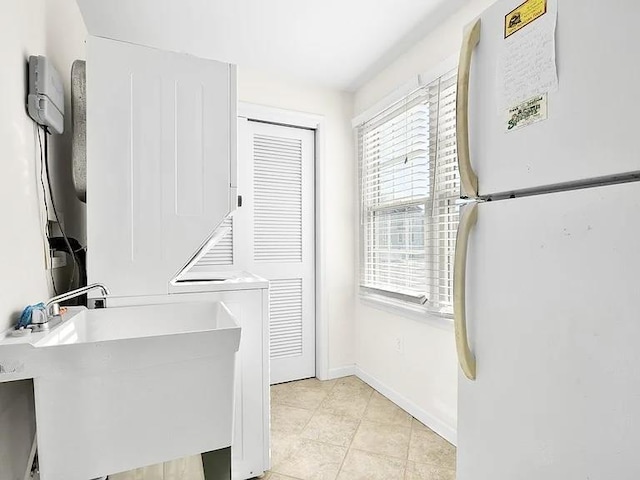 367 21st St, Avalon, NJ 08202 - washroom with stacked washer / dryer and light tile patterned floors
