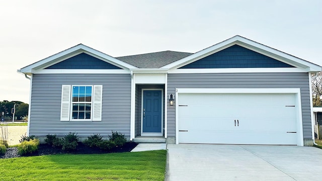 view of front of home with a front lawn and a garage