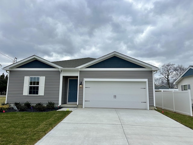 view of front of home featuring a garage and a front yard