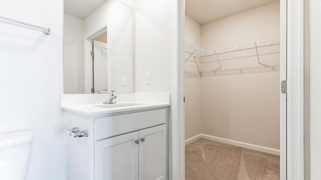 bathroom featuring vanity and toilet